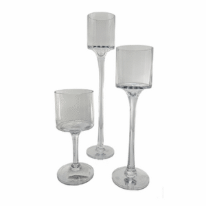 Three glass candle holders with stems of varying sizes made for shorter candles