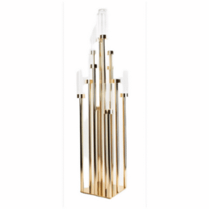 A piece with several gold pillars with glass candle holders attached at the top in varying heights