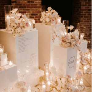 White rectangular pedestals with floral and candle arrangements
